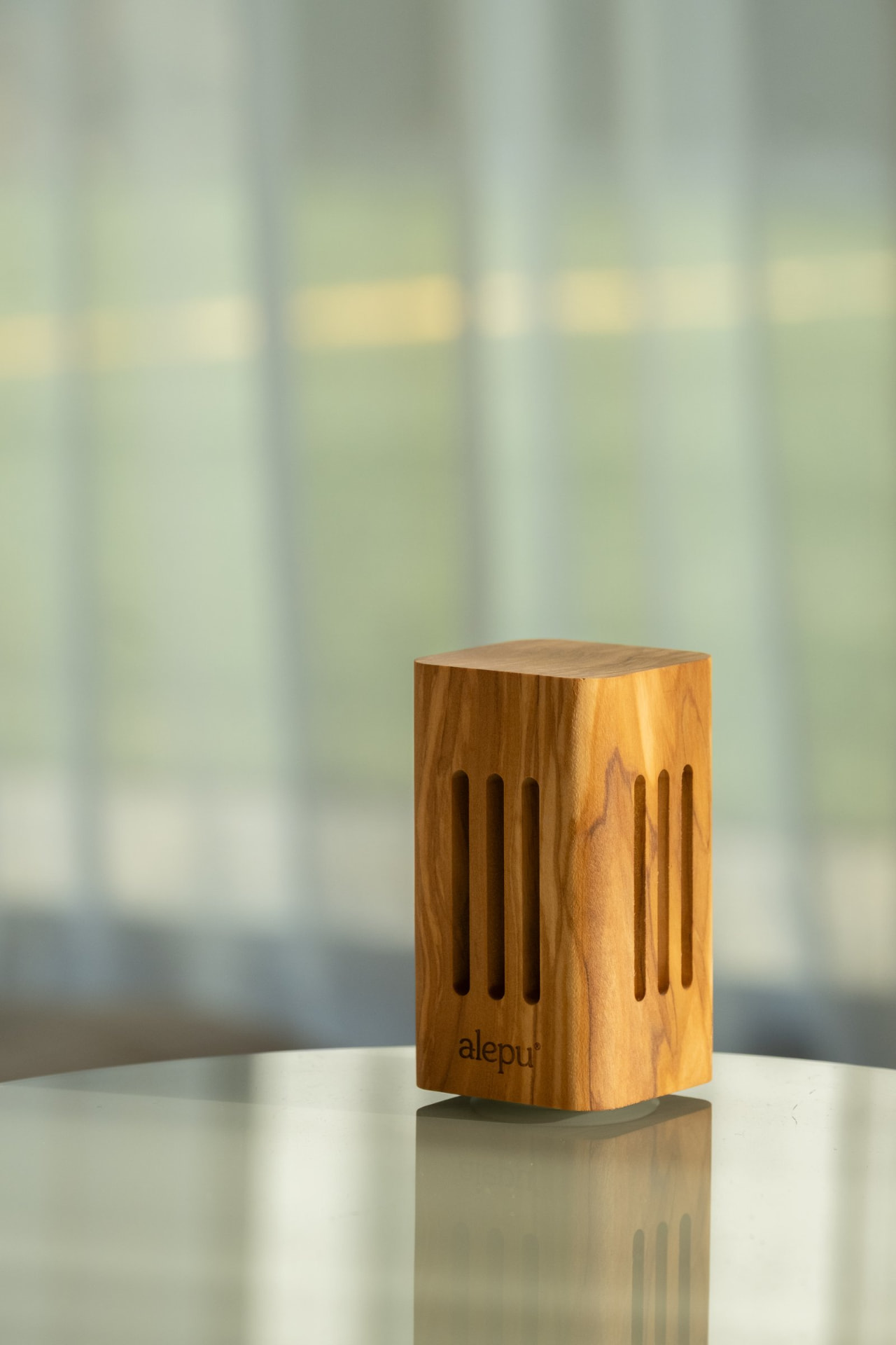 A square olive wood diffuser, its slotted sides showing the grain