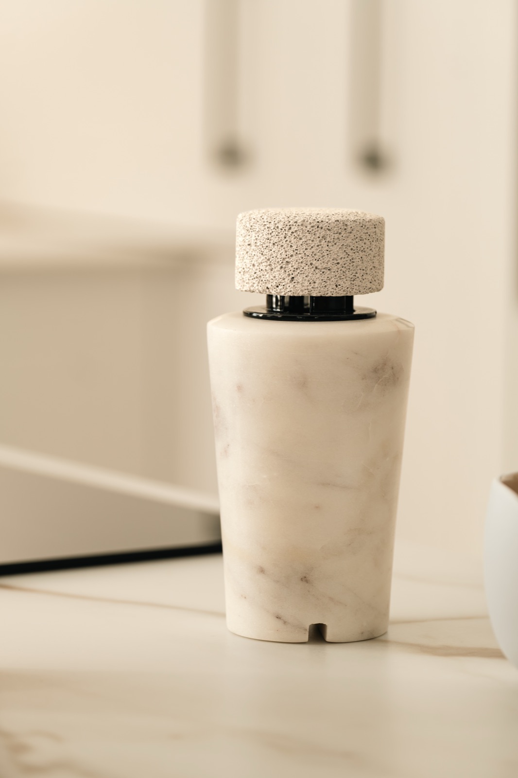 Close view of a white marble diffuser and its porous pumice cap