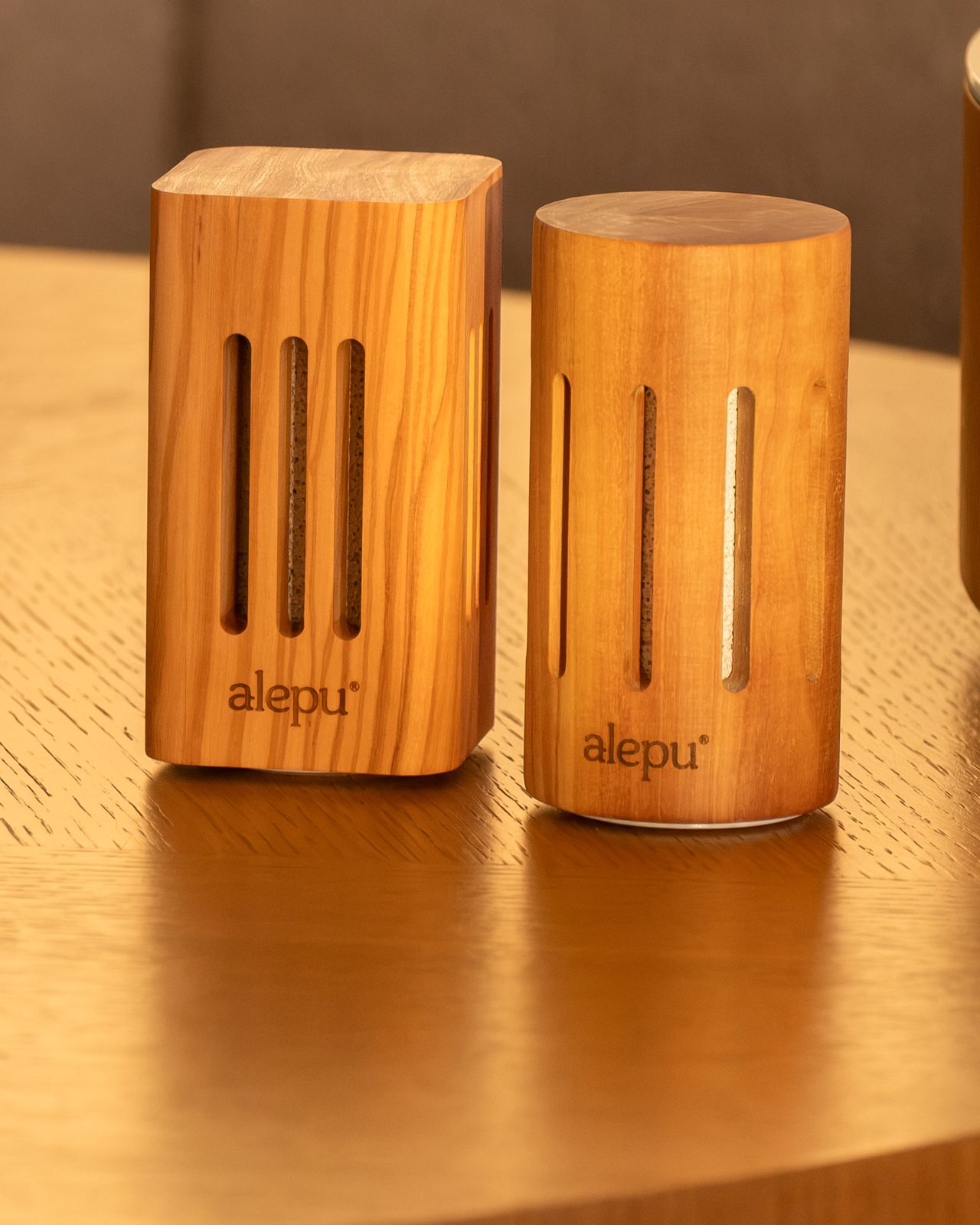 The square and round olive wood diffusers with the alepu logo engraved into the wood